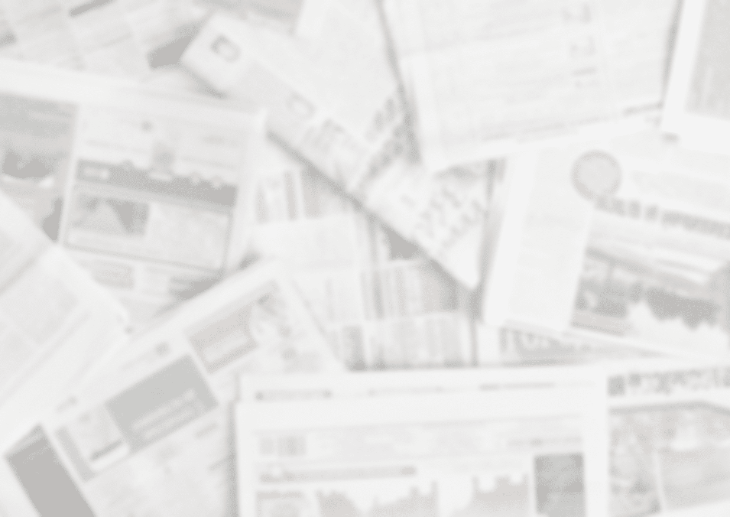 Lots of old newspapers on horizontal surface. Background texture, top view, blurred